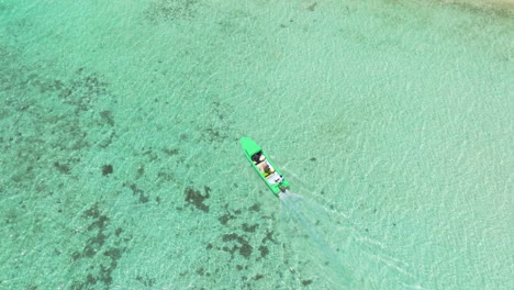 Wooden-Boat-Sailing-On-Crystal-Clear-Waters-Of-Moso-Island,-Vanuatu