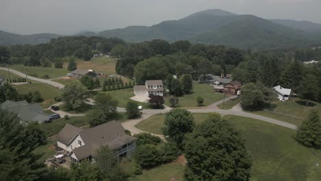 aerial view of manicured yards of country estate homes in misty mtns