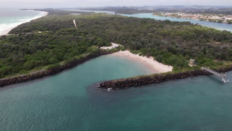 drone shot over marlo's beach by the tweed river in nsw australia