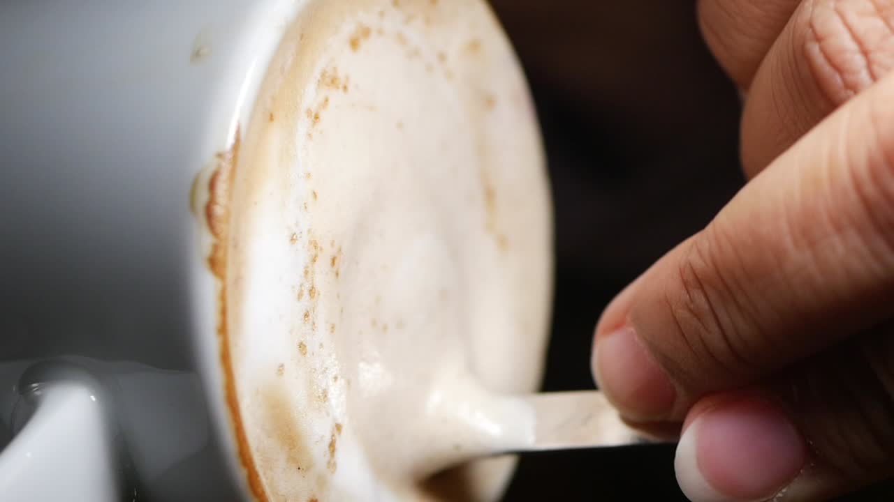 Stirring coffee with a spoon