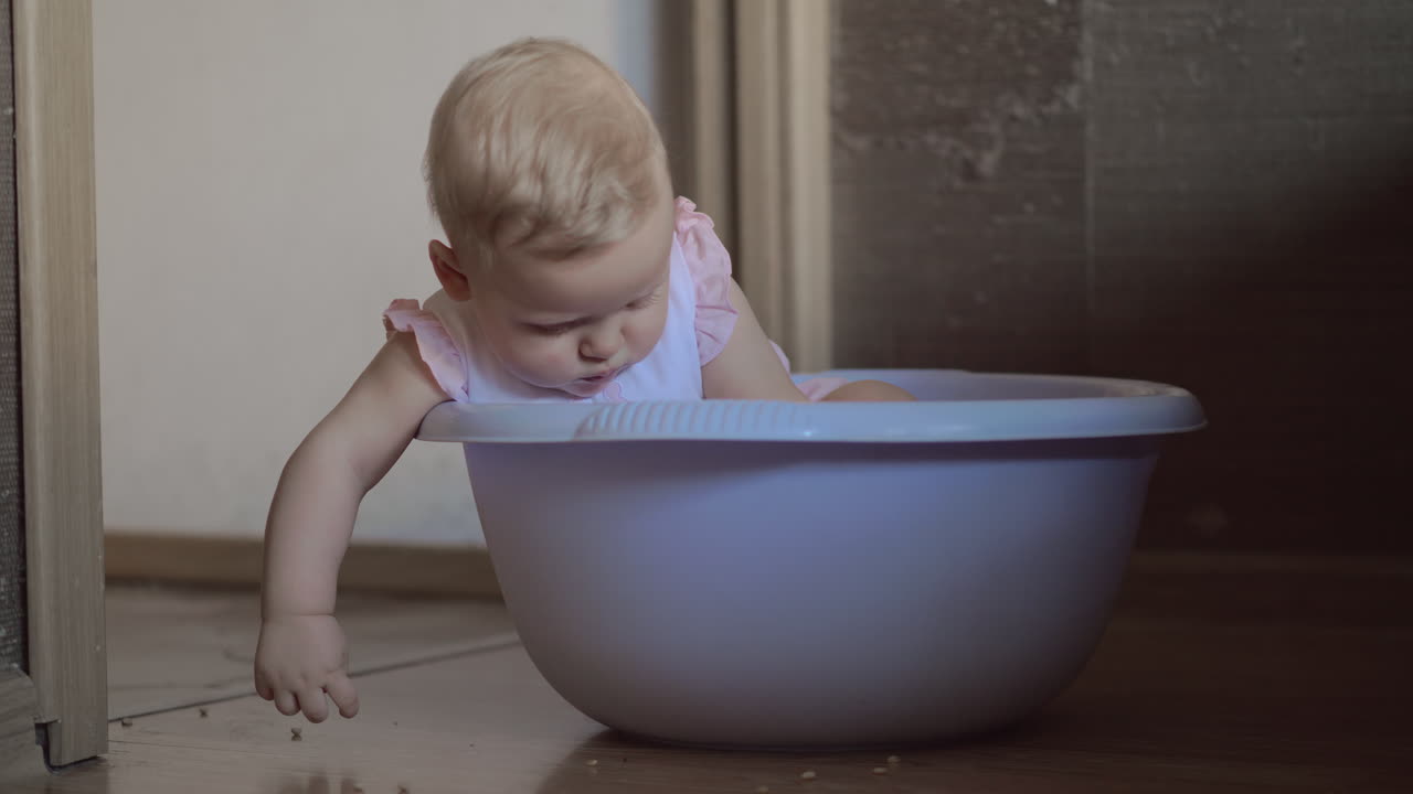 Cute baby girl in a round blue tub 3