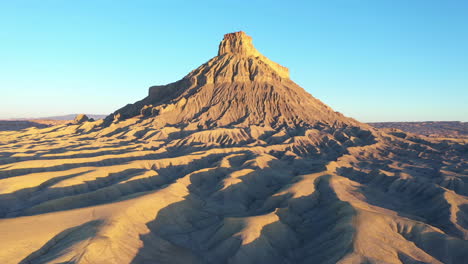 Aerial-tilt-down-over-desert,-Factory-Butte,-Utah