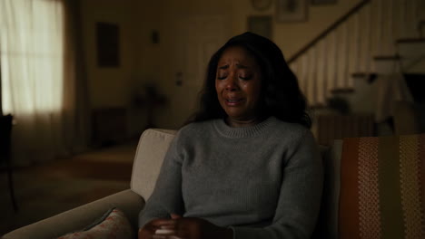 a woman crying and wiping tears with a tissue