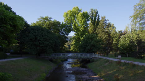 A-Small-Pedestrian-Bridge-Over-A-Canal-In-A-Park-In-Baden-Baden,-Germany