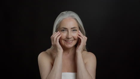 happy senior woman with skincare