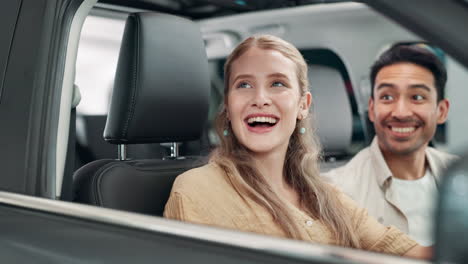 couple excited about their new car purchase at the dealership
