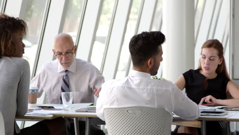 Business-Team-Meeting-Around-Boardroom-Table-Shot-On-R3D