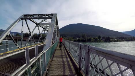 Woman-riding-unicycle-on-the-bridge-4k