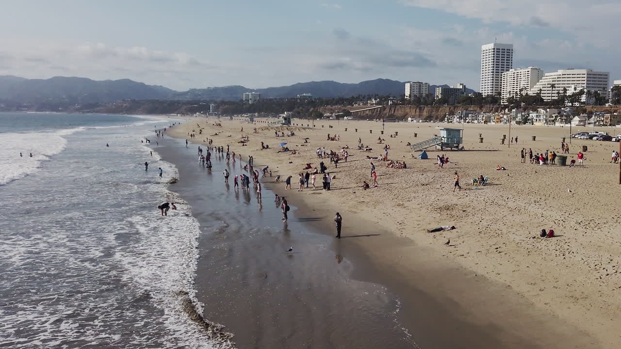 Aerial view of Santa Monica Beach filled with people enjoying the sun and waves