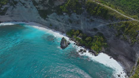 tourist attraction diamond beach on tropical island nusa penida, vibrant blue water, aerial