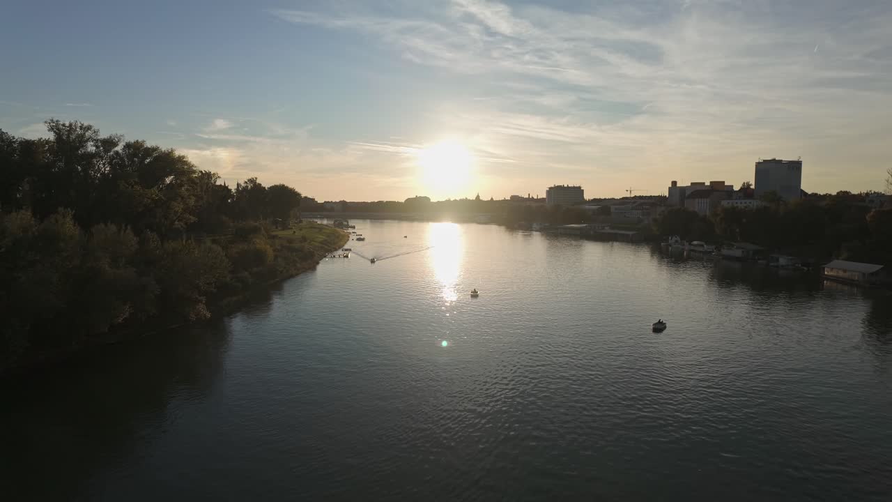 Szeged skyline from the Tisza River in the shadow of the setting sun in Hungary
