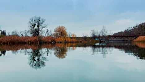 autumn reflection on river with bridge
