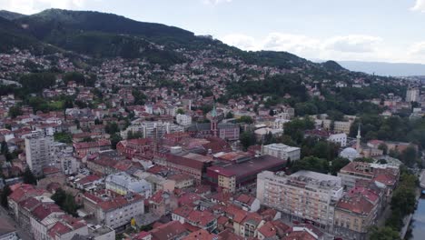 Aerial-of-Sarajevo-showcasing-the-Church-of-Saint-Anthony-and-surrounding-mountains