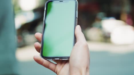 Handheld-view-of-man-holding-green-screen-smart-phone