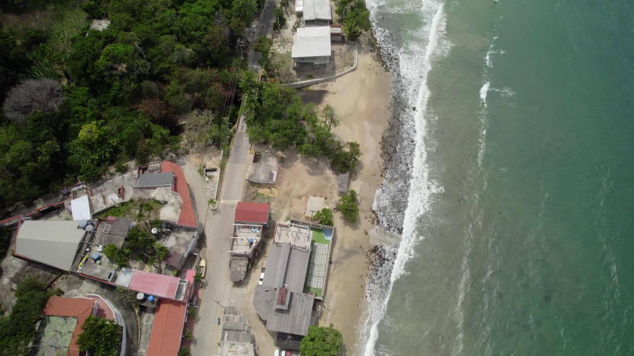 Drone view of Playa Urama coastline with beach, village, and water along Caribbean