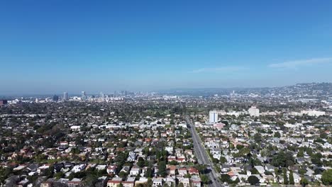 aerial push in drone shot over larchmont neighborhood during early morning