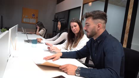 Diverse-colleagues-working-at-table-in-office