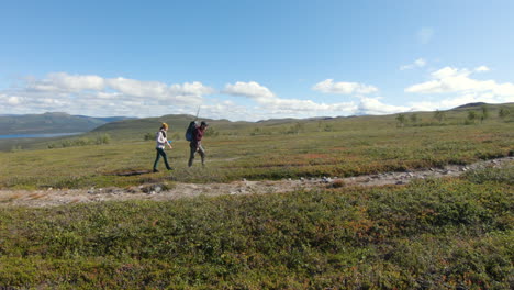 man and woman hiking in the beautiful nature of saltoluokta, northern sweden