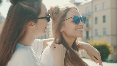 two women friends enjoying sunny day in city