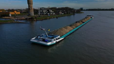 Sand-loaded-general-cargo-ship-Avelie-sailing-through-river-Oude-Mass,-Dordrecht,-The-Netherlands