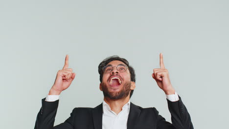 a man in a suit pointing and smiling with a happy expression