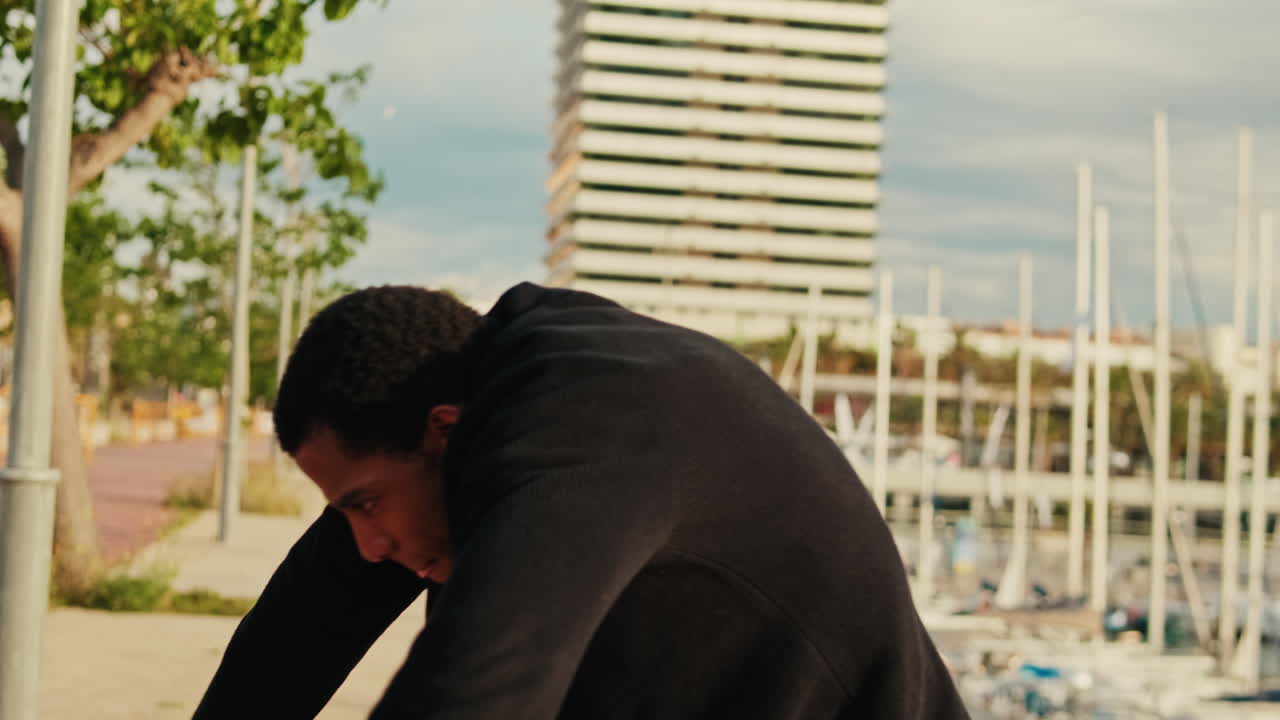 Energetic Young Man Stretching and Dancing in Urban Marina