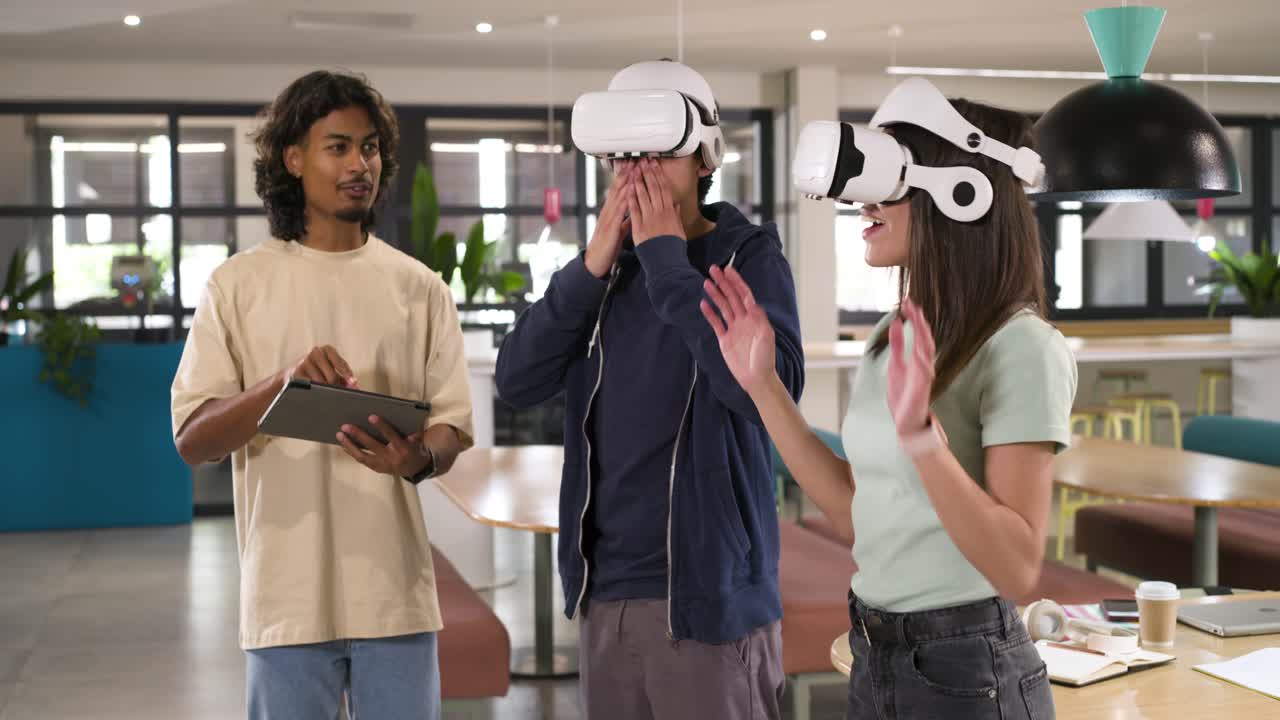 African American coworkers running VR test with white headsets, operator tapping tablet in lounge