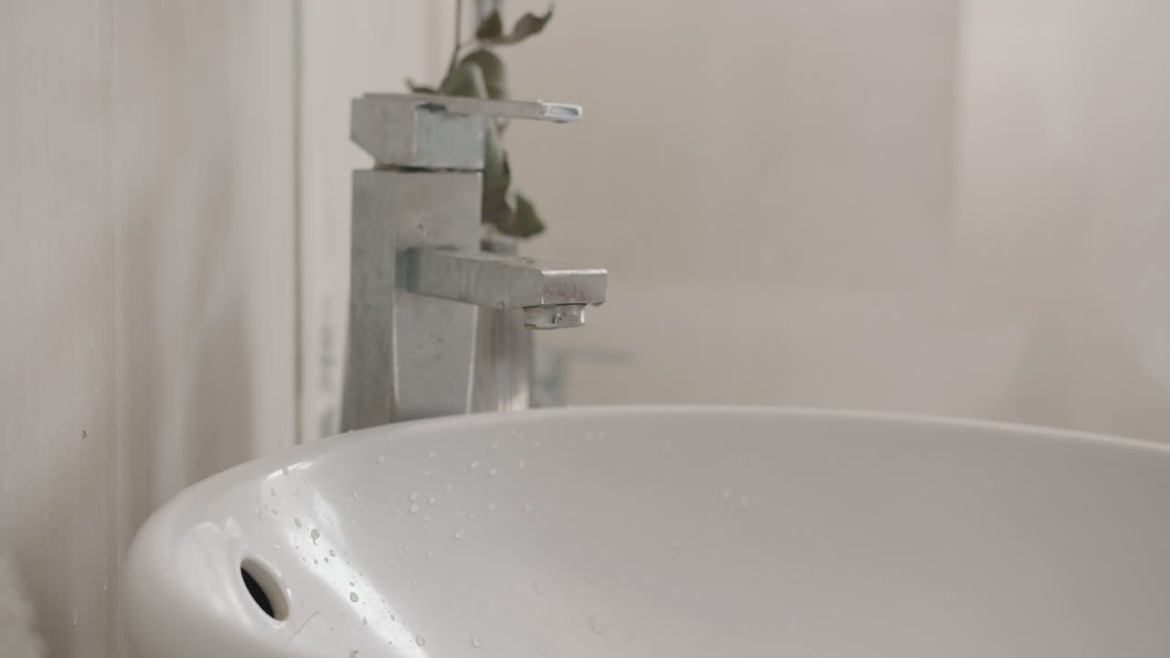 Hands of Woman Washing Toothbrush in Sink