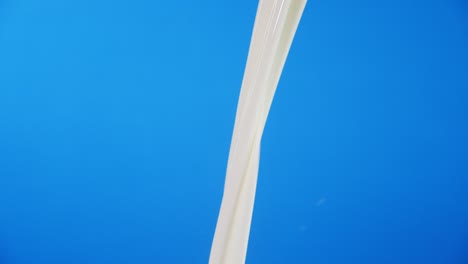 the jet of fresh milk poured from a can.