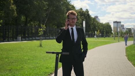 businessman using phone in a park