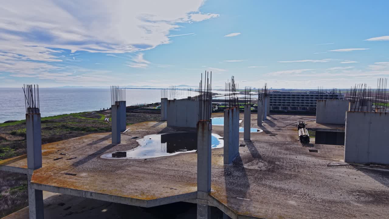Abandoned building structure with ocean view in aerial perspective