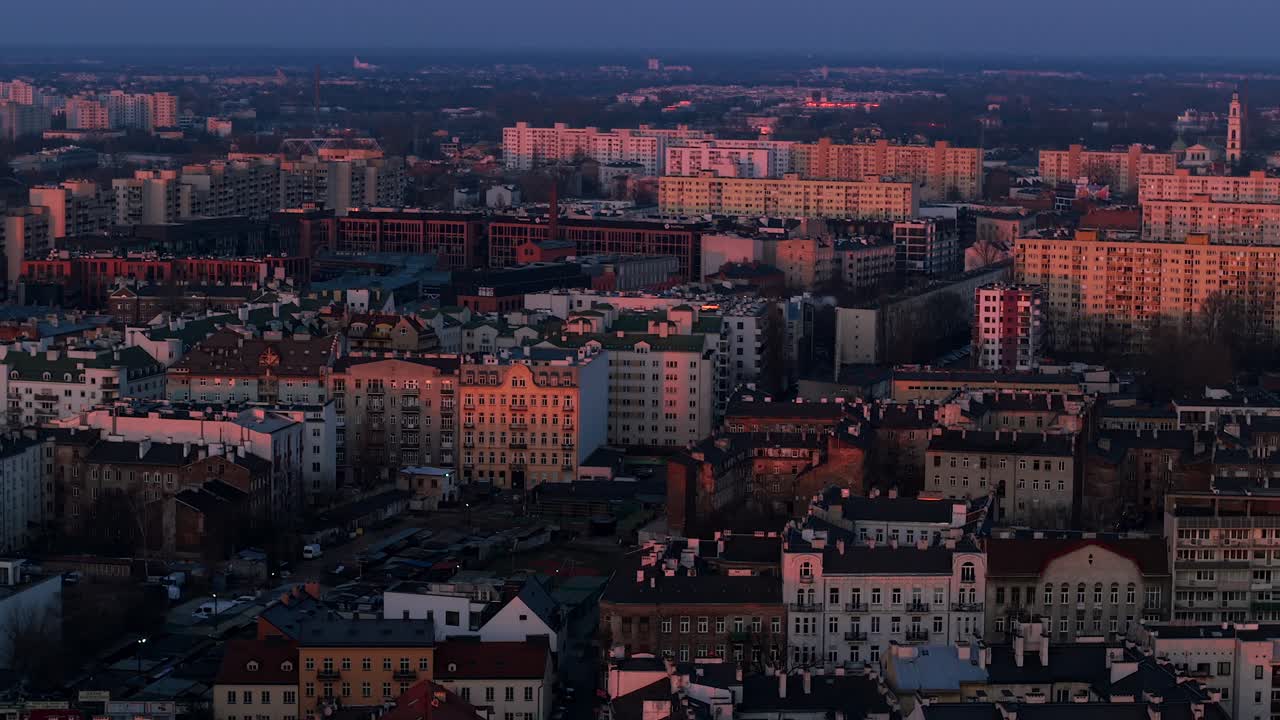 Aerial shot of Warsaw's Praga district with sunset light highlighting 70s and 80s buildings