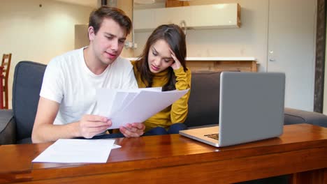 couple watching television in living room