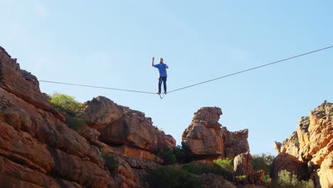 man falling from slackline in rocky mountains 4k