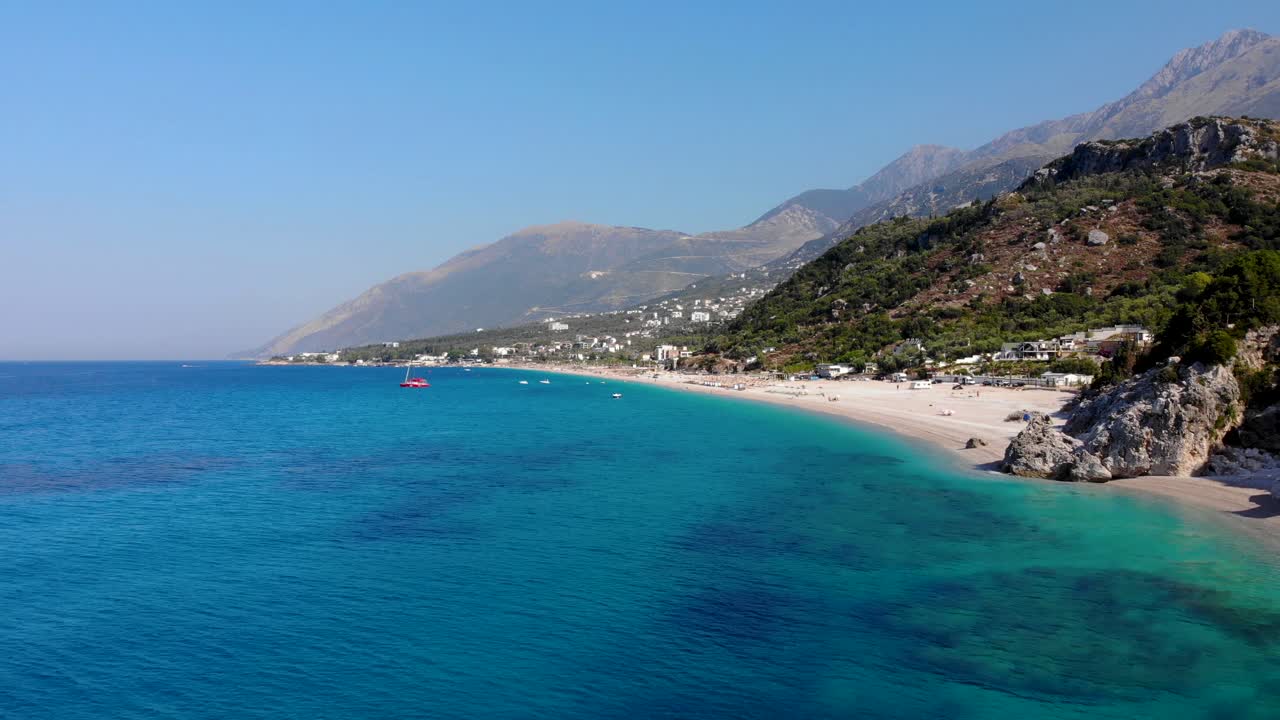 Paradise beach on a remote tranquil coastline in Mediterranean surrounded by rocks and azure sea water