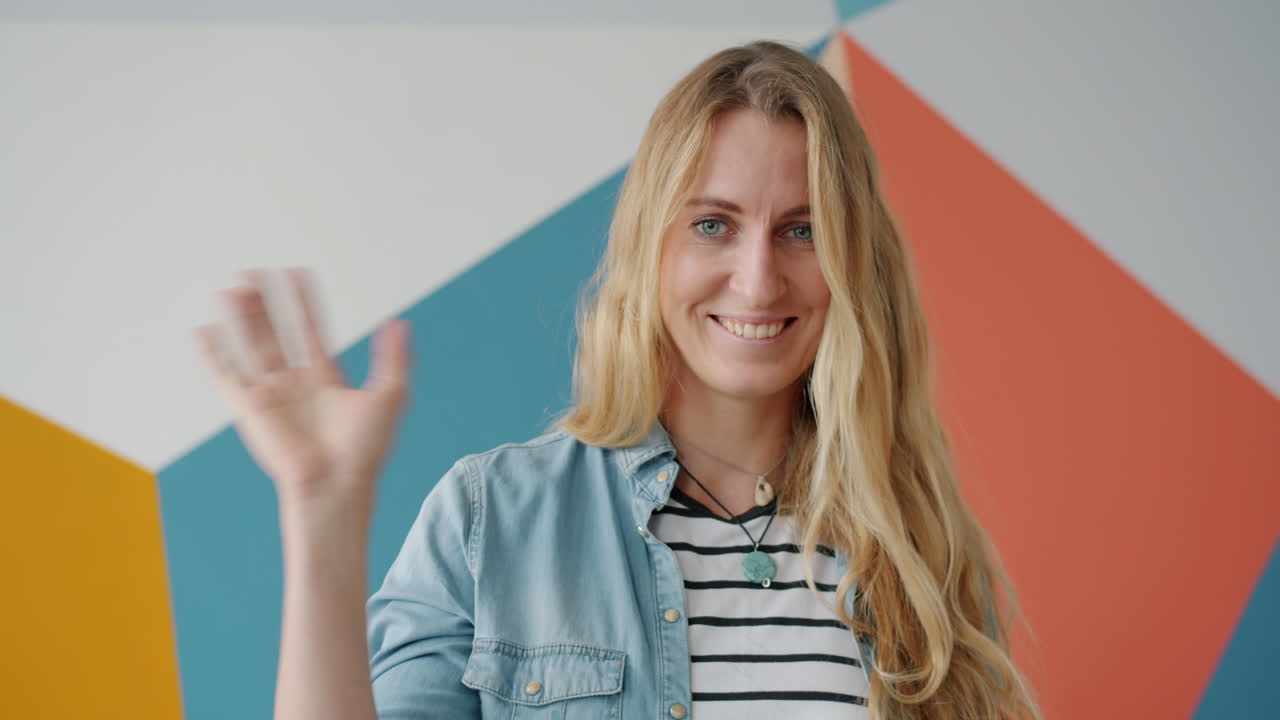 una mujer saludando.