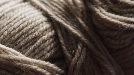 micro video of close up of brown wool thread with copy space