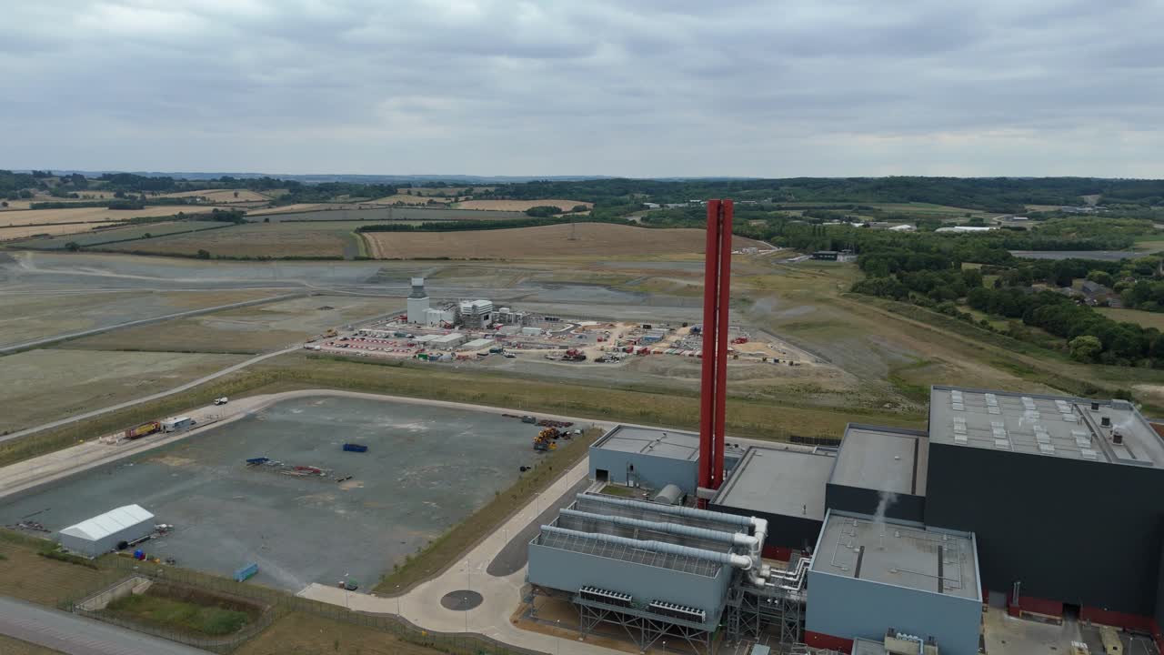 Drone aerial footage of Bedford power station UK showing tall chimney stacks, fossil fuel electricity production and heavy industrial infrastructure