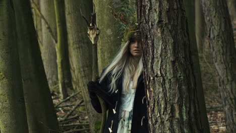 Wiccan-girl-with-natural-headdress-from-grass-walking-into-camera,-slow-motion