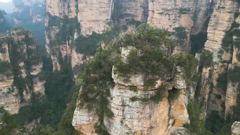 aerial orbiting shot of the columns with fog in zhangjiajie national park, avatar hallelujah mountains, china