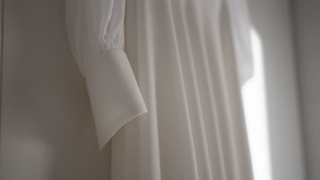 elegant close up of a white dress sleeve showcasing delicate fabric texture