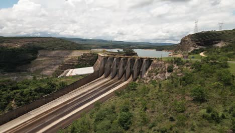 cinematic drone footage - flying sideways over the river showing a hydroeletric at minas gerais in brazil