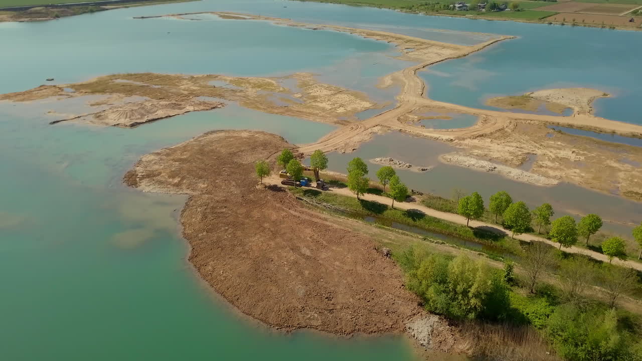 Aerial drone shot of flying at the lake for a sand mining site in The Netherlands, Europe.