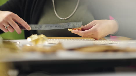 measuring metal parts with a ruler for jewelry making