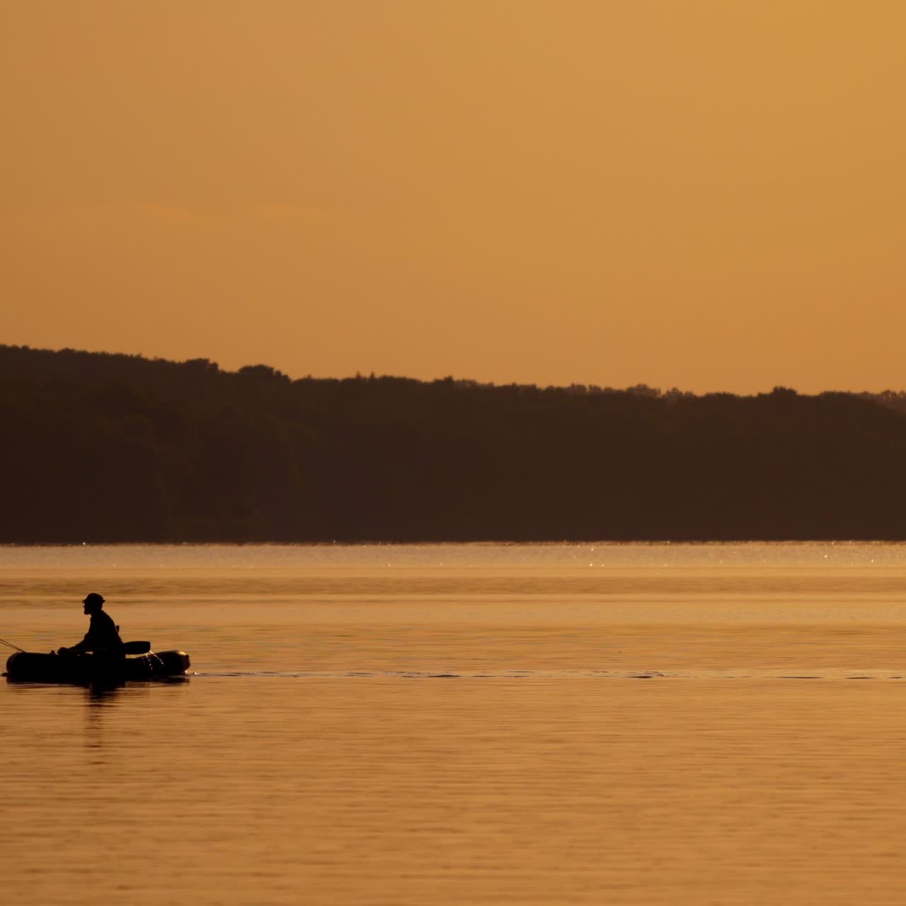 Silhouette of fisherman in boat