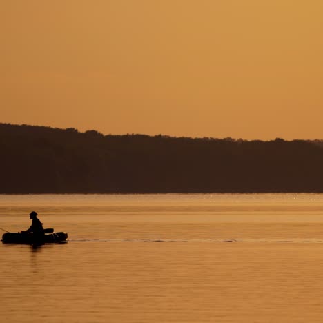 silhouette of fisherman in boat