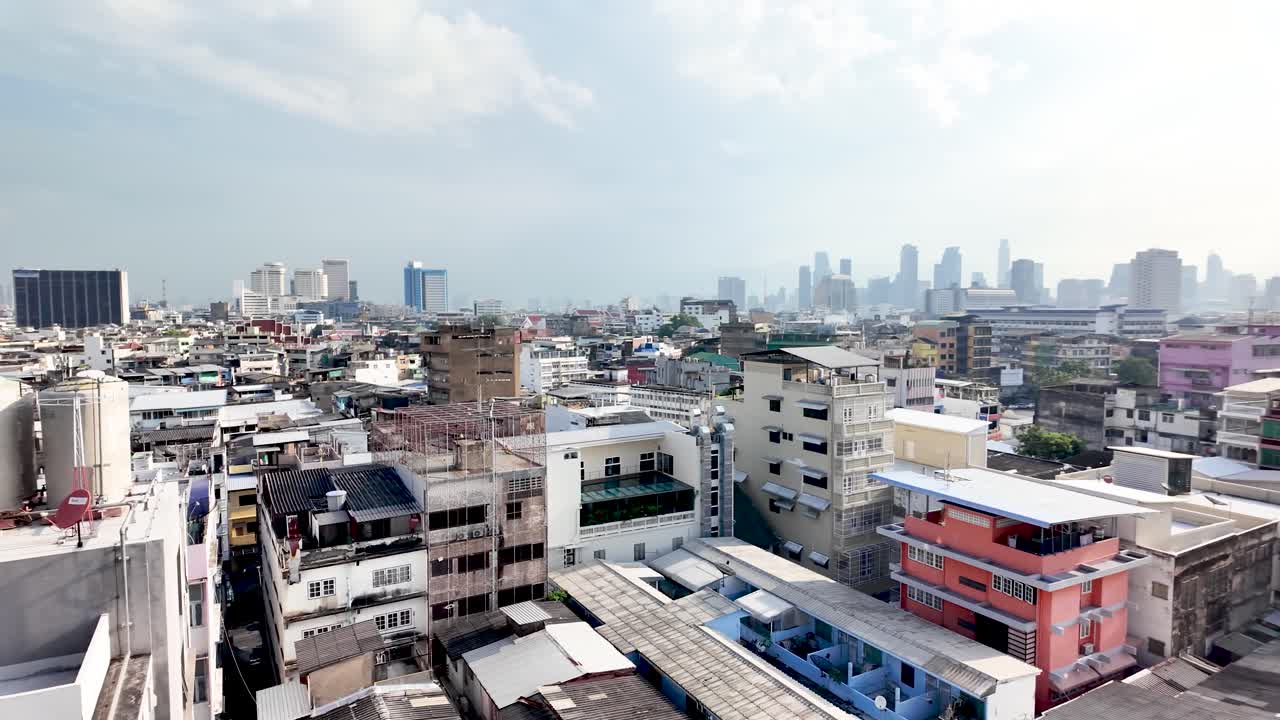 Bangkok Samphanthawong District buildings and rooftops under clear sky, showing urban development