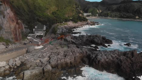 Rotating-aerial-shot-of-outdoor-Japanese-Hotsprings-next-to-ocean-on-Kozushima-Island