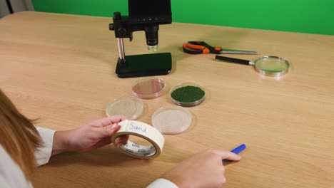 examining and labeling soil samples in petri dishes