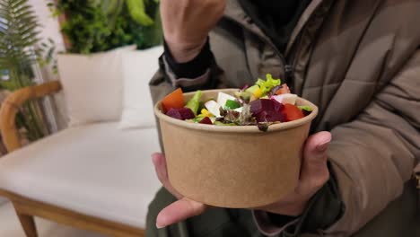 woman eating a colorful salad